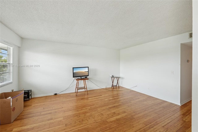 13450 SW 3rd St Unit 408D, Pembroke Pines, FL 33027 - empty room with hardwood / wood-style flooring and a textured ceiling