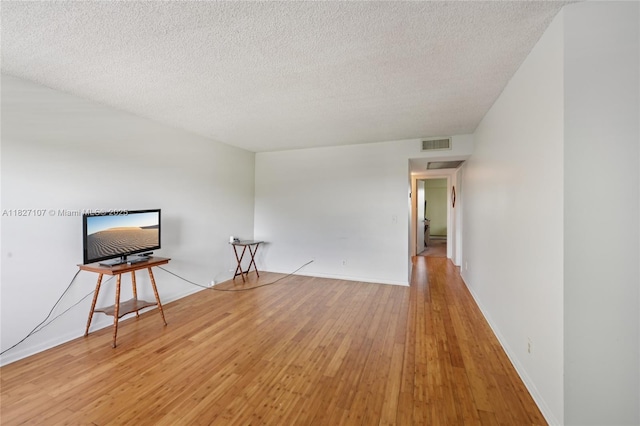 13450 SW 3rd St Unit 408D, Pembroke Pines, FL 33027 - unfurnished room with light wood-style flooring and a textured ceiling