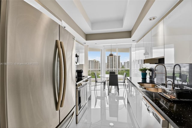 7000 Island Blvd Unit 1408, Aventura, FL 33160 - kitchen with appliances with stainless steel finishes, white cabinetry, modern cabinets, a view of city, and a wall of windows