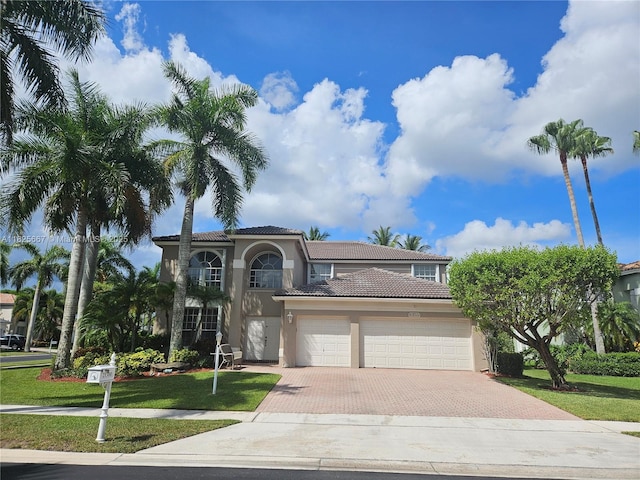 21300 Waycross Dr, Boca Raton, FL 33428 - mediterranean / spanish home with a tile roof, decorative driveway, stucco siding, and an attached garage
