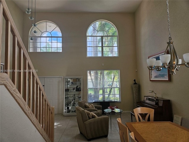 21300 Waycross Dr, Boca Raton, FL 33428 - living room with light tile patterned floors, stairs, plenty of natural light, a high ceiling, and a chandelier