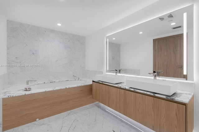 1135 103rd St Unit 408, Bay Harbor Islands, FL 33154 - bathroom with double vanity, marble tiled flooring, recessed lighting, and a garden tub