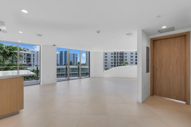 1135 103rd St Unit 408, Bay Harbor Islands, FL 33154 - spare room with floor to ceiling windows, recessed lighting, electric panel, and a city view