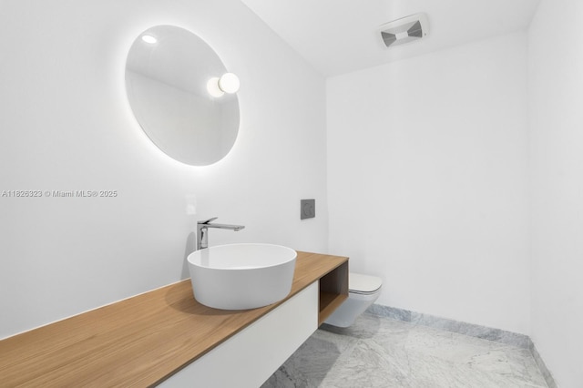 1135 103rd St Unit 408, Bay Harbor Islands, FL 33154 - bathroom featuring vanity and marble finish flooring