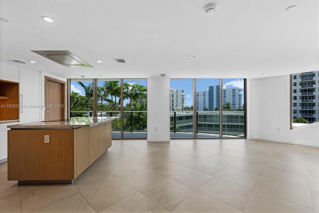 1135 103rd St Unit 408, Bay Harbor Islands, FL 33154 - kitchen featuring floor to ceiling windows, modern cabinets, a center island, healthy amount of natural light, and open floor plan