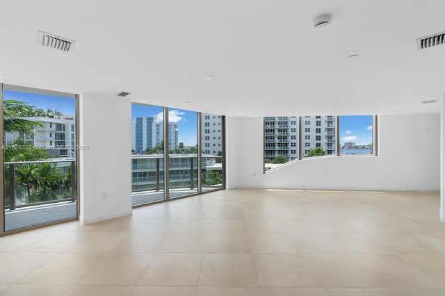 1135 103rd St Unit 408, Bay Harbor Islands, FL 33154 - unfurnished room with a smoke detector, a city view, and tile patterned flooring