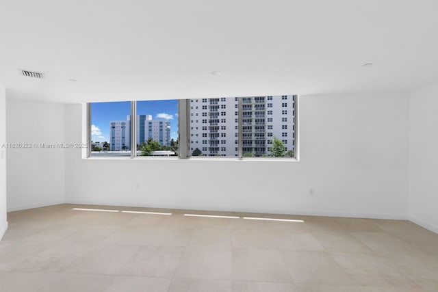 1135 103rd St Unit 408, Bay Harbor Islands, FL 33154 - unfurnished room featuring baseboards and a city view