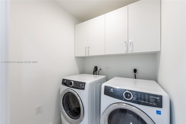 851 NE 1st Ave Unit 3308, Miami, FL 33132 - washroom with cabinet space and independent washer and dryer