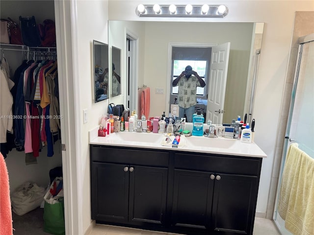 134 NE 23rd Ter, Homestead, FL 33033 - bathroom with a shower stall, a spacious closet, and double vanity