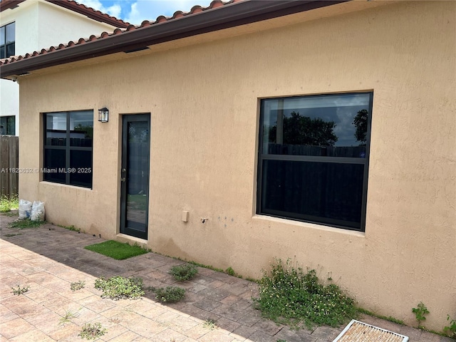 134 NE 23rd Ter, Homestead, FL 33033 - entrance to property with a patio, stucco siding, and a tiled roof