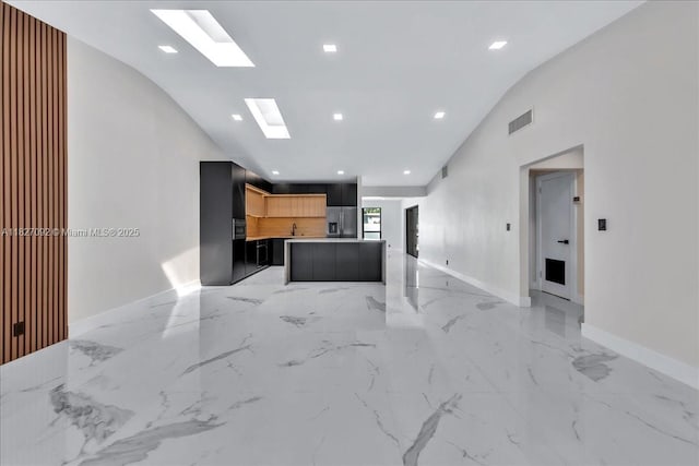 5890 SW 13th St, Plantation, FL 33317 - living area with vaulted ceiling, light marble finish floors, a skylight, and recessed lighting