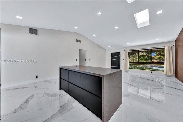 5890 SW 13th St, Plantation, FL 33317 - kitchen with modern cabinets, a center island, a skylight, vaulted ceiling, and light marble finish flooring