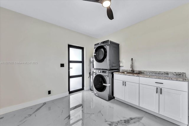 5890 SW 13th St, Plantation, FL 33317 - washroom featuring stacked washer / drying machine, cabinet space, a ceiling fan, and light marble finish flooring