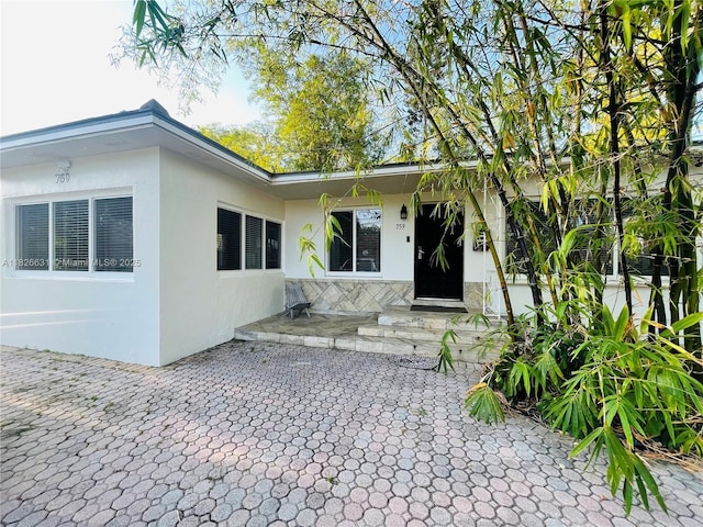 759 NE 87th St, Miami, FL 33138 - entrance to property with stucco siding and a patio