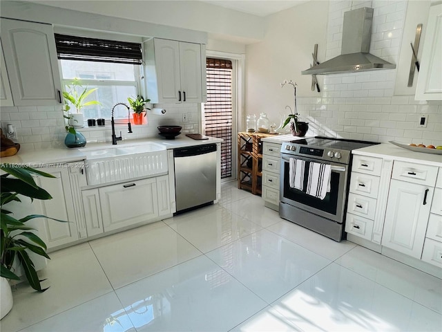 759 NE 87th St, Miami, FL 33138 - kitchen with stainless steel appliances, wall chimney exhaust hood, decorative backsplash, light countertops, and light tile patterned floors