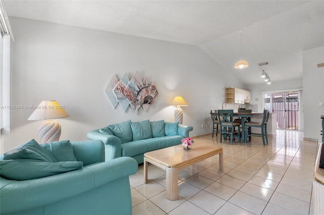 7101 W 24th Ave Unit 27, Hialeah, FL 33016 - living area featuring vaulted ceiling, light tile patterned floors, and rail lighting