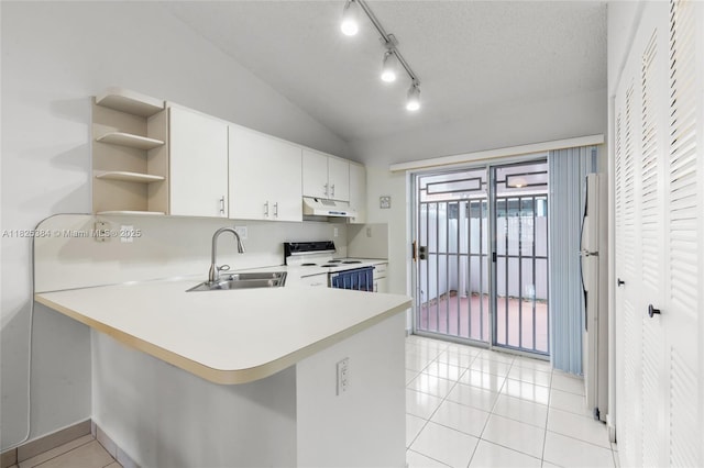 7101 W 24th Ave Unit 27, Hialeah, FL 33016 - kitchen with white electric range oven, under cabinet range hood, light countertops, a peninsula, and vaulted ceiling