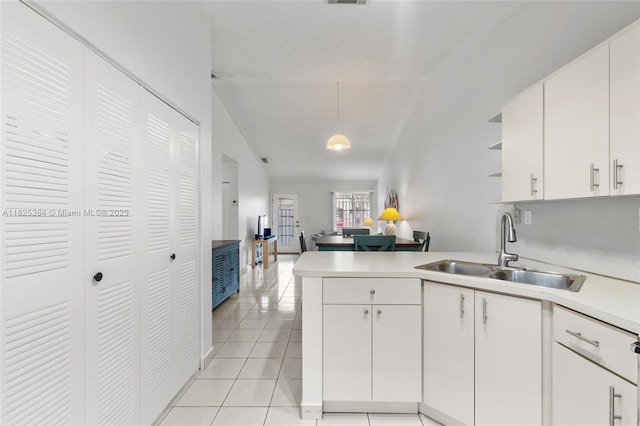 7101 W 24th Ave Unit 27, Hialeah, FL 33016 - kitchen featuring a peninsula, light countertops, lofted ceiling, open shelves, and light tile patterned floors