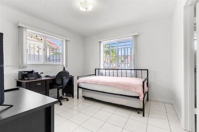 7101 W 24th Ave Unit 27, Hialeah, FL 33016 - bedroom with a desk, a textured ceiling, and light tile patterned floors