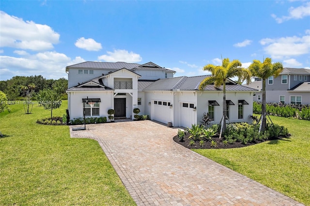 20161 SE Bridgewater Dr, Jupiter, FL 33458 - modern farmhouse with an attached garage, a standing seam roof, a front yard, decorative driveway, and a metal roof