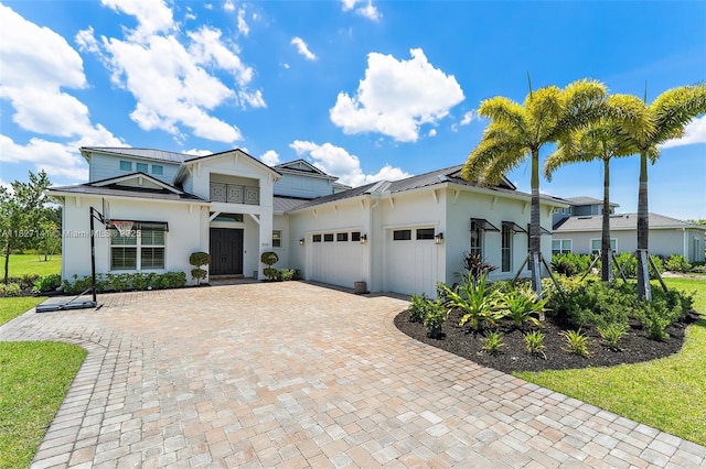 20161 SE Bridgewater Dr, Jupiter, FL 33458 - modern farmhouse featuring an attached garage, a standing seam roof, stucco siding, and a metal roof
