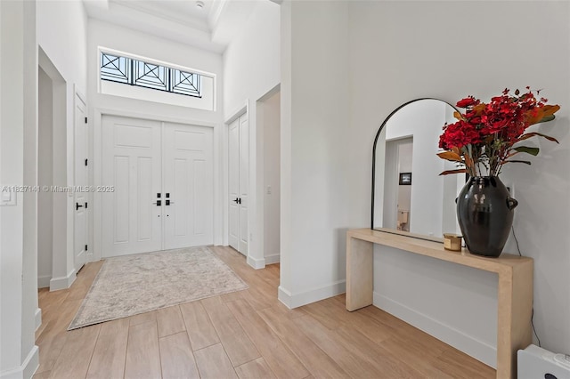 20161 SE Bridgewater Dr, Jupiter, FL 33458 - foyer with light wood-type flooring, a high ceiling, and a skylight
