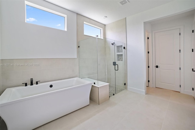 20161 SE Bridgewater Dr, Jupiter, FL 33458 - bathroom with a freestanding tub, a stall shower, and tile patterned flooring