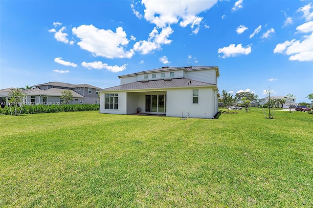 20161 SE Bridgewater Dr, Jupiter, FL 33458 - back of house with a metal roof, a lawn, a standing seam roof, and stucco siding