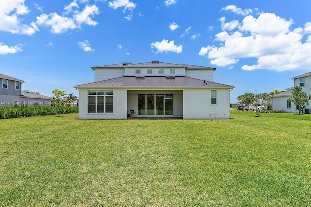 20161 SE Bridgewater Dr, Jupiter, FL 33458 - rear view of house featuring a standing seam roof, stucco siding, and a yard