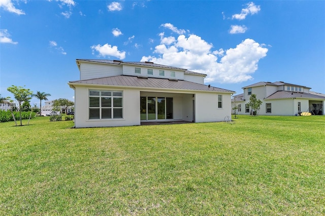 20161 SE Bridgewater Dr, Jupiter, FL 33458 - rear view of property featuring a lawn, a metal roof, a standing seam roof, and stucco siding
