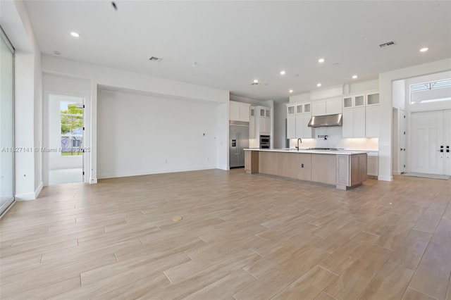 20161 SE Bridgewater Dr, Jupiter, FL 33458 - unfurnished living room with light wood finished floors and recessed lighting