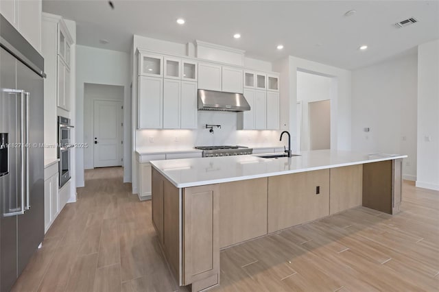 20161 SE Bridgewater Dr, Jupiter, FL 33458 - kitchen featuring extractor fan, appliances with stainless steel finishes, a large island, light wood-style floors, and recessed lighting