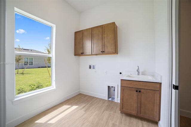 20161 SE Bridgewater Dr, Jupiter, FL 33458 - laundry area featuring electric dryer hookup, washer hookup, healthy amount of natural light, and light wood-type flooring