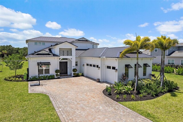 20161 SE Bridgewater Dr, Jupiter, FL 33458 - modern farmhouse with a standing seam roof, a metal roof, a garage, and a front yard