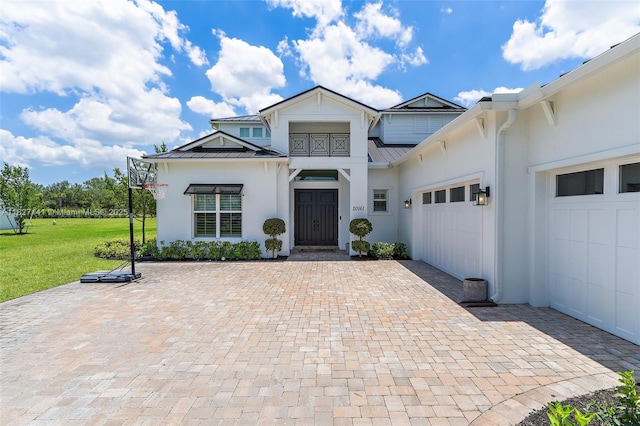 20161 SE Bridgewater Dr, Jupiter, FL 33458 - view of front of property with a standing seam roof, a garage, stucco siding, and a metal roof