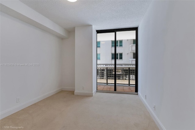9455 Collins Ave Unit 301, Surfside, FL 33154 - carpeted spare room with a wall of windows and a textured ceiling