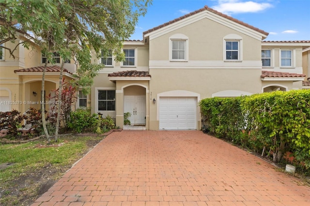3818 SW 171st Ter, Miramar, FL 33027 - view of property with decorative driveway, a tiled roof, a garage, and stucco siding