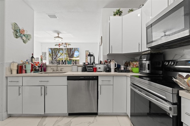 3818 SW 171st Ter, Miramar, FL 33027 - kitchen featuring appliances with stainless steel finishes, light countertops, and white cabinetry