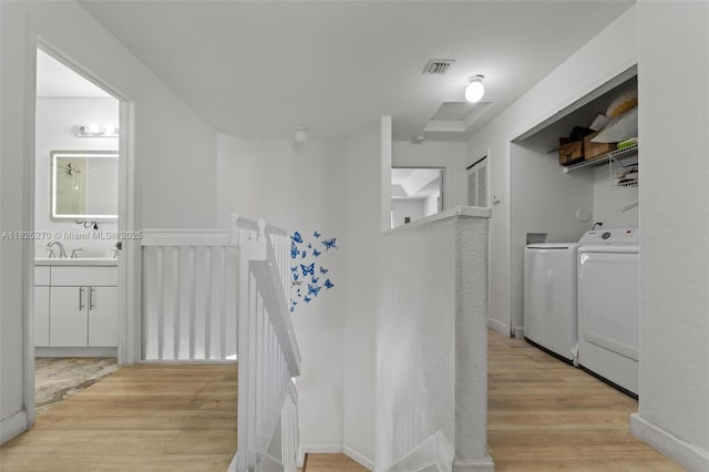 3818 SW 171st Ter, Miramar, FL 33027 - hall featuring separate washer and dryer, an upstairs landing, and light wood-style floors