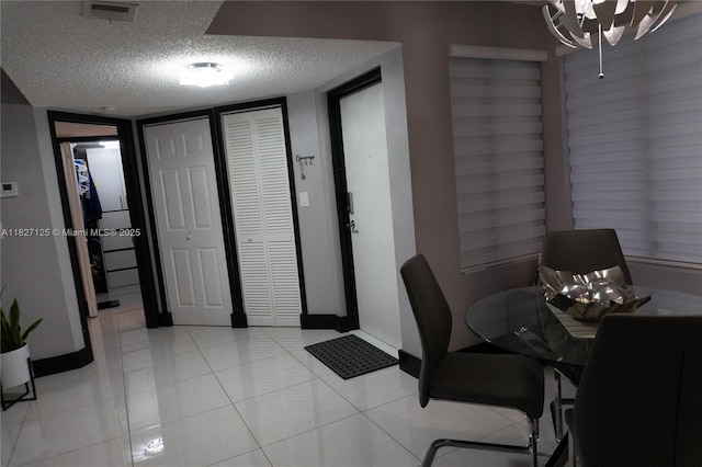 8215 SW 152nd Ave Unit G-307, Miami, FL 33193 - office area with a textured ceiling, light tile patterned flooring, and a chandelier