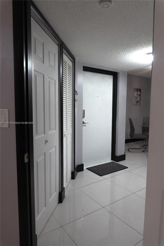 8215 SW 152nd Ave Unit G-307, Miami, FL 33193 - corridor with a textured ceiling and light tile patterned floors