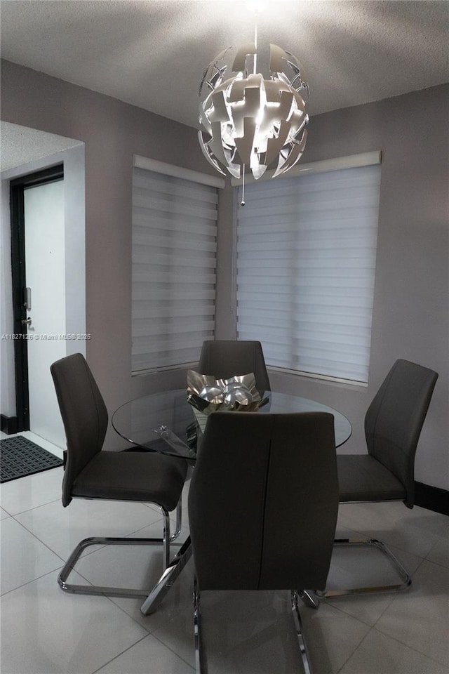 8215 SW 152nd Ave Unit G-307, Miami, FL 33193 - dining area featuring a chandelier, tile patterned flooring, and a textured ceiling