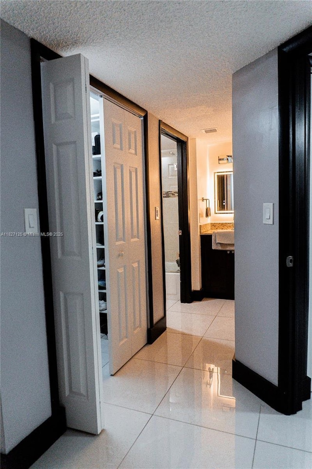 8215 SW 152nd Ave Unit G-307, Miami, FL 33193 - corridor featuring light tile patterned floors and a textured ceiling