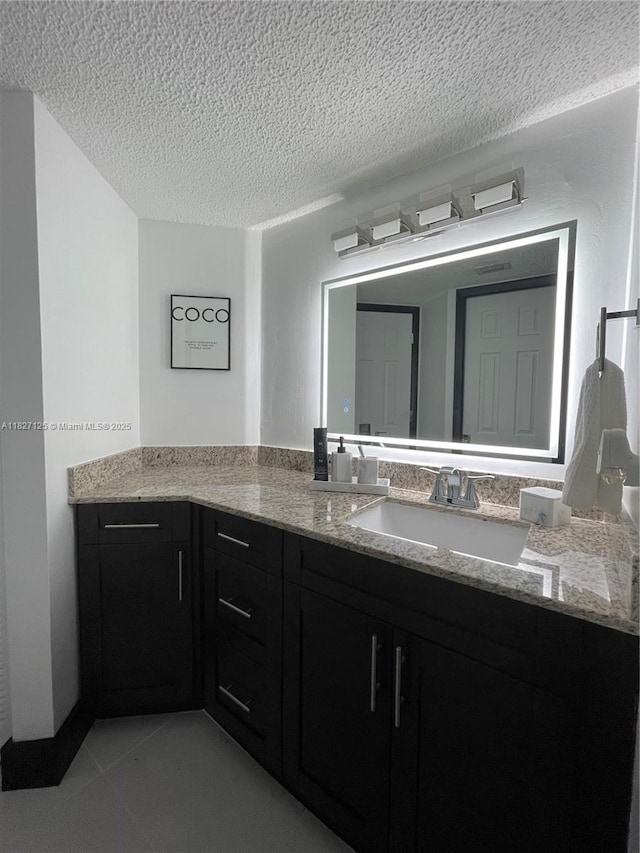 8215 SW 152nd Ave Unit G-307, Miami, FL 33193 - bathroom featuring a textured ceiling, vanity, and tile patterned flooring