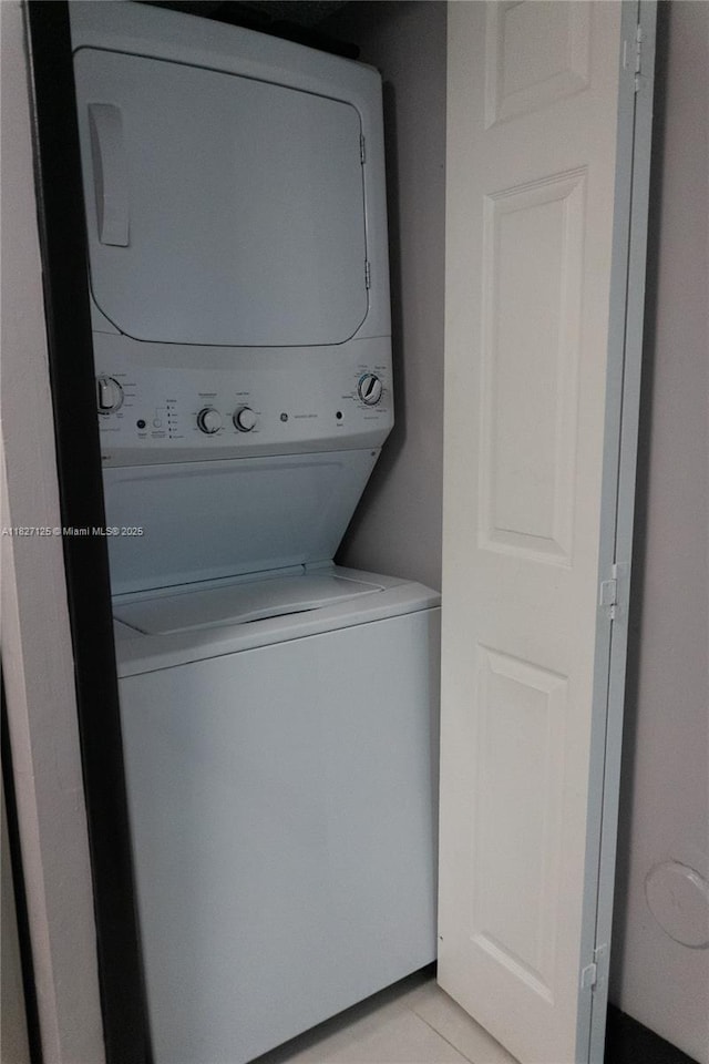 8215 SW 152nd Ave Unit G-307, Miami, FL 33193 - laundry room with stacked washer and clothes dryer and light tile patterned floors