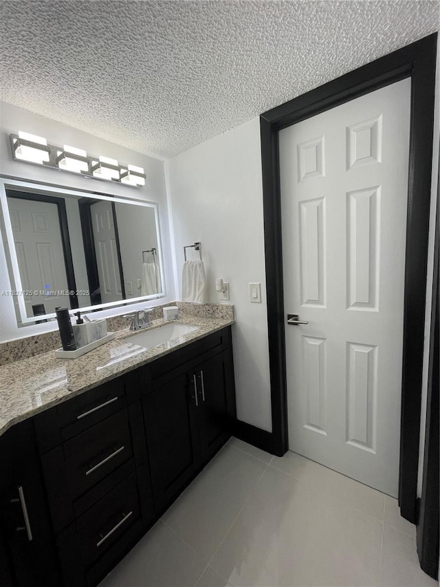 8215 SW 152nd Ave Unit G-307, Miami, FL 33193 - bathroom featuring tile patterned floors, vanity, and a textured ceiling