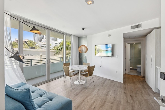 6080 Collins Ave Unit 302, Miami Beach, FL 33140 - dining room featuring plenty of natural light and light wood-type flooring