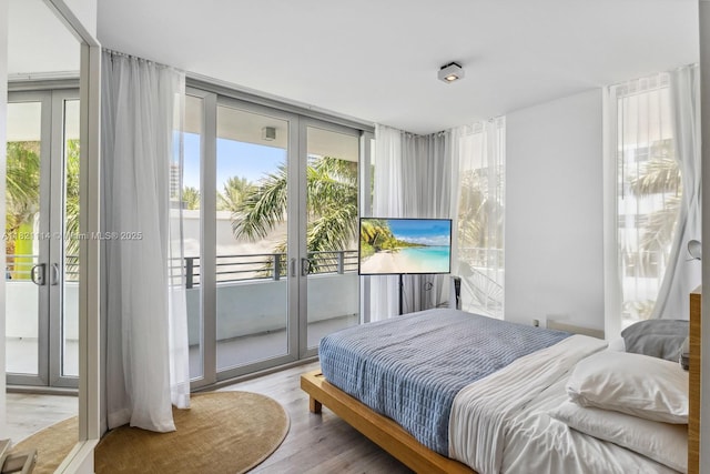 6080 Collins Ave Unit 302, Miami Beach, FL 33140 - bedroom with french doors, access to exterior, multiple windows, and wood finished floors