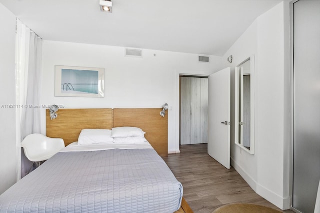 6080 Collins Ave Unit 302, Miami Beach, FL 33140 - bedroom featuring wood finished floors and baseboards
