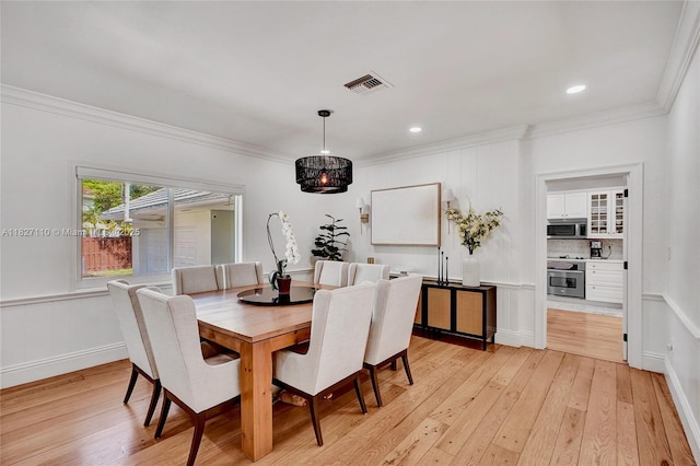 6731 SW 138th St, Palmetto Bay, FL 33158 - dining room with crown molding, light wood finished floors, recessed lighting, a wainscoted wall, and a chandelier